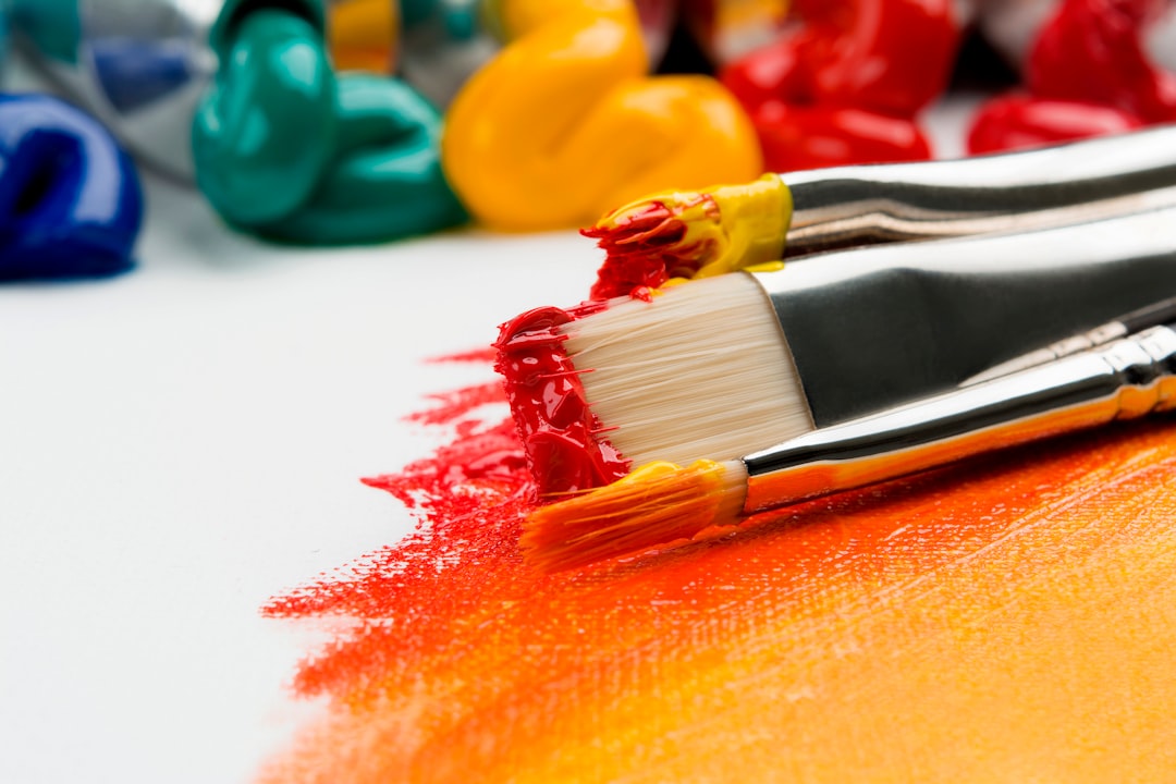 Close-up of paintbrushes with paint on canvas